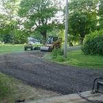 AFTER - Final grade complete, rolling the crushed asphalt with our vibrating roller.  This creates a perfectly flat driving surface.  Mike's new gravel paved crushed asphalt driveway complete!